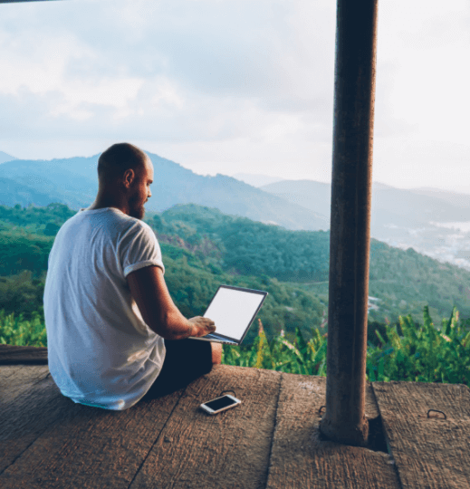 man on holiday using computer
