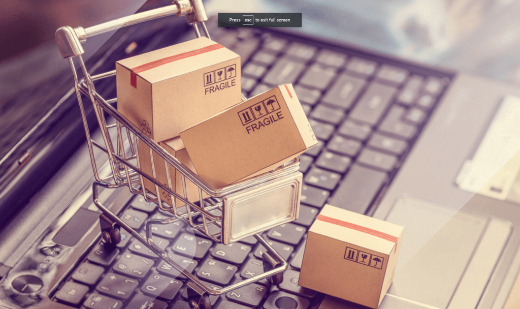 Boxes with shopping cart on a laptop computer keyboard for marketing for ecommerce shops