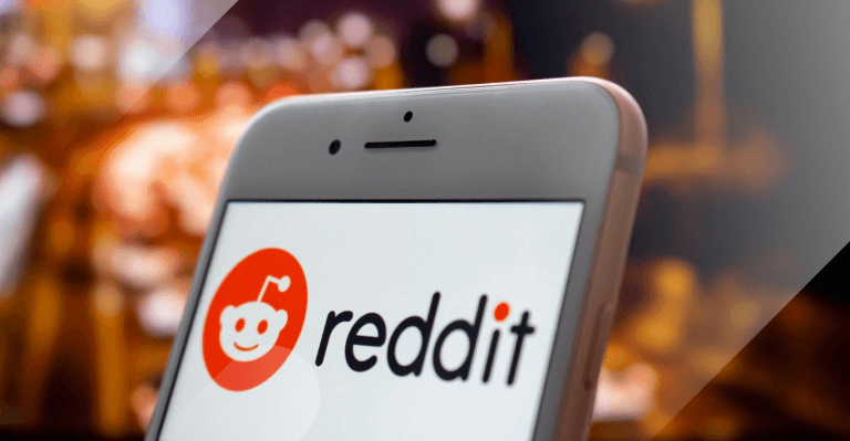 Reddit IPO - Reddit on a phone with the background of a city
